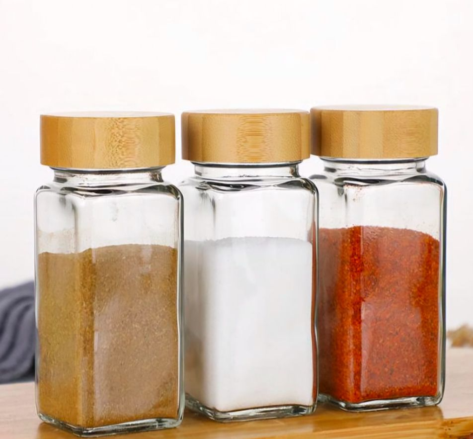 Salt and pepper glass shaker with wood lid